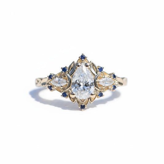 #27 18K White Gold Pear and blue sapphire accents Ring